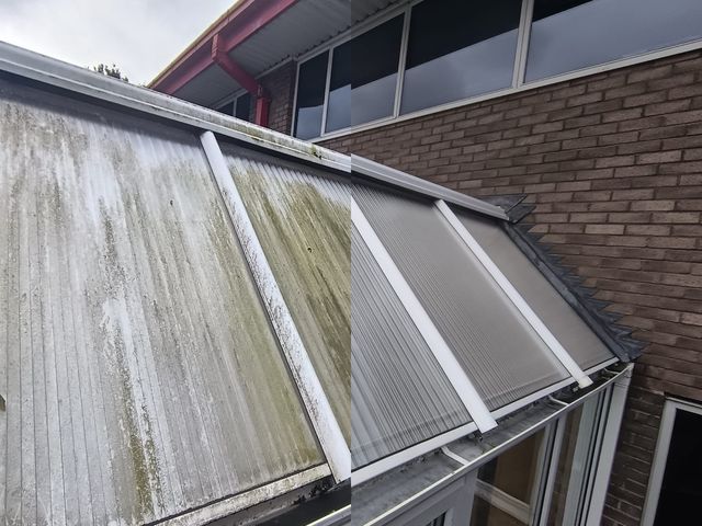 A conservatory roof, the left half streaked with green algae before cleaning and the right half clean after
